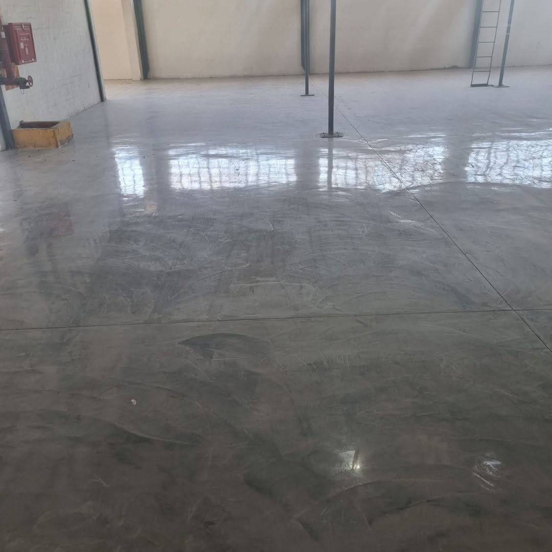 Freshly resurfaced concrete warehouse floor with a smooth trowelled overlay finish
